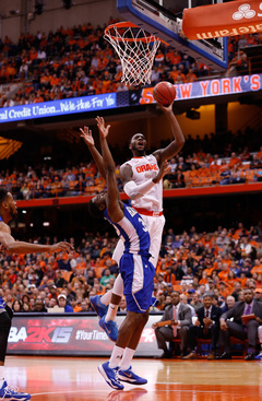 SU center Rakeem Christmas attempts a left-handed finish near the rim.