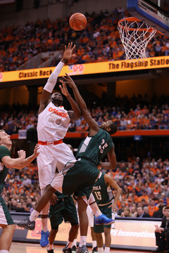 Christmas flicks a shot over Loyola guard Chancellor Barnard from the paint.