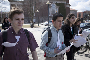 (from left) Azor Cole, Jose Godinez, Christina Gandy and Laura Kleinberg, members of United Students Against Sweatshops hand out flyers on Wednesday afternoon. The students wore paper ties, which they later cut, to symbolize their desire to see SU end its relationship with Adidas.