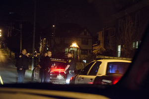 Syracuse police gather near where students reported being robbed at gunpoint late Wednesday night in the 200 block of Ostrom Avenue. 