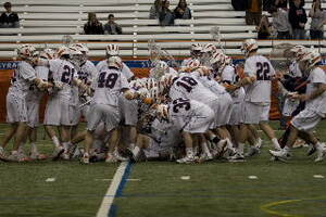 Syracuse midfielder Brendan Loftus is mobbed by his team after hitting the game winning shot