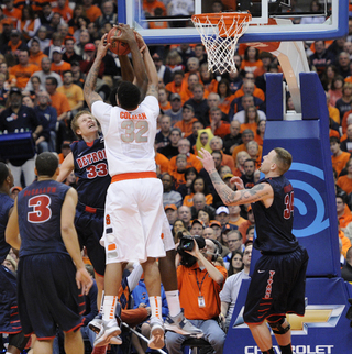 Syracuse center DaJuan Coleman blocks a shot on Detroit's Even Bruinsma.