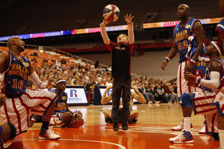 Scooter, Big Easy and other players look on, praying for the volunteer's shot to find a way into the basket. 