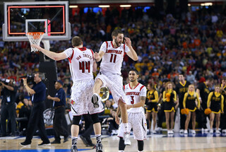 Luke Hancock and Stephen Van Treese celebrate during a timeout as Louisville came back to take the lead.