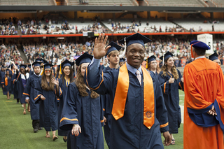 Syracuse students march inside the Carrier Dome on Sunday morning as a part of the 2013 commencement ceremony.