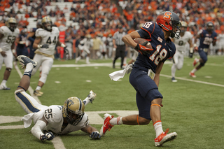 SU wide receiver Christopher Clark slips past the Pitt defense for a gain.