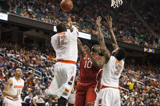 Keita goes up for a loose ball in a crowd. 