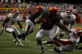 SU running back Prince-Tyson Gulley tries to shake off Wolfpack linebacker Rodman Noel near the Orange's own goal line.