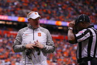 SU head coach Scott Shafer talks to a referee on the sideline. 