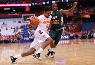 Gbinije attacks the basket from the right side.