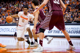 Michael Gbinije tries a step-back offensively as Roh defends and Nic Lane looks on. 