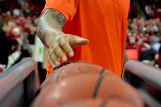 Injured Syracuse forward DaJuan Coleman goes to grab a ball from the ball rack before Saturday's season finale at North Carolina State.