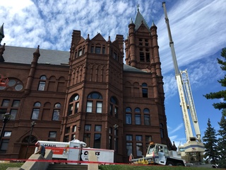 Cranes and other construction equipment is set up around Crouse College in preparation for the addition of new bells to the building's bell tower. Photo taken Aug. 17, 2016